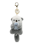Fluffy plush otter keychain holding little fish, kawaii bag accessory