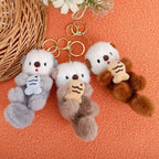 Cute otter plush charm hanging on backpack, animal lover gift